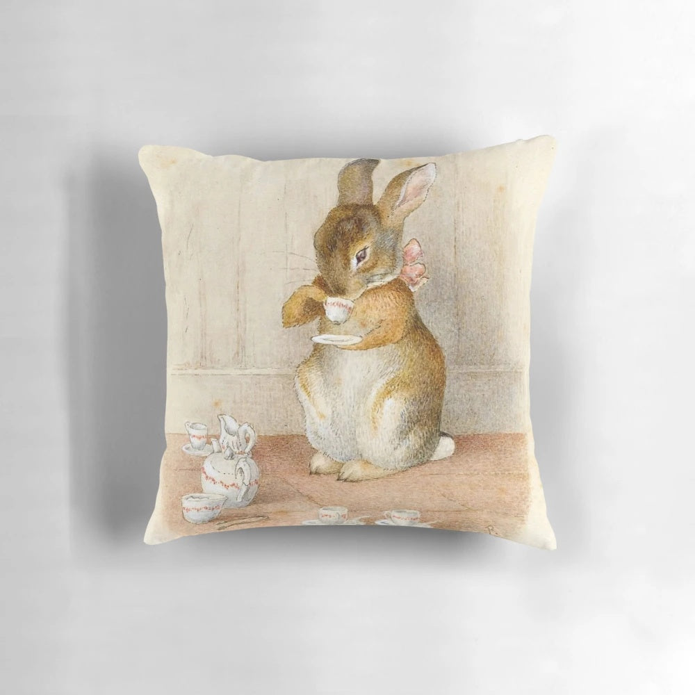 Vintage-style decorative pillow featuring a whimsical rabbit tea party scene inspired by the art of Beatrix Potter