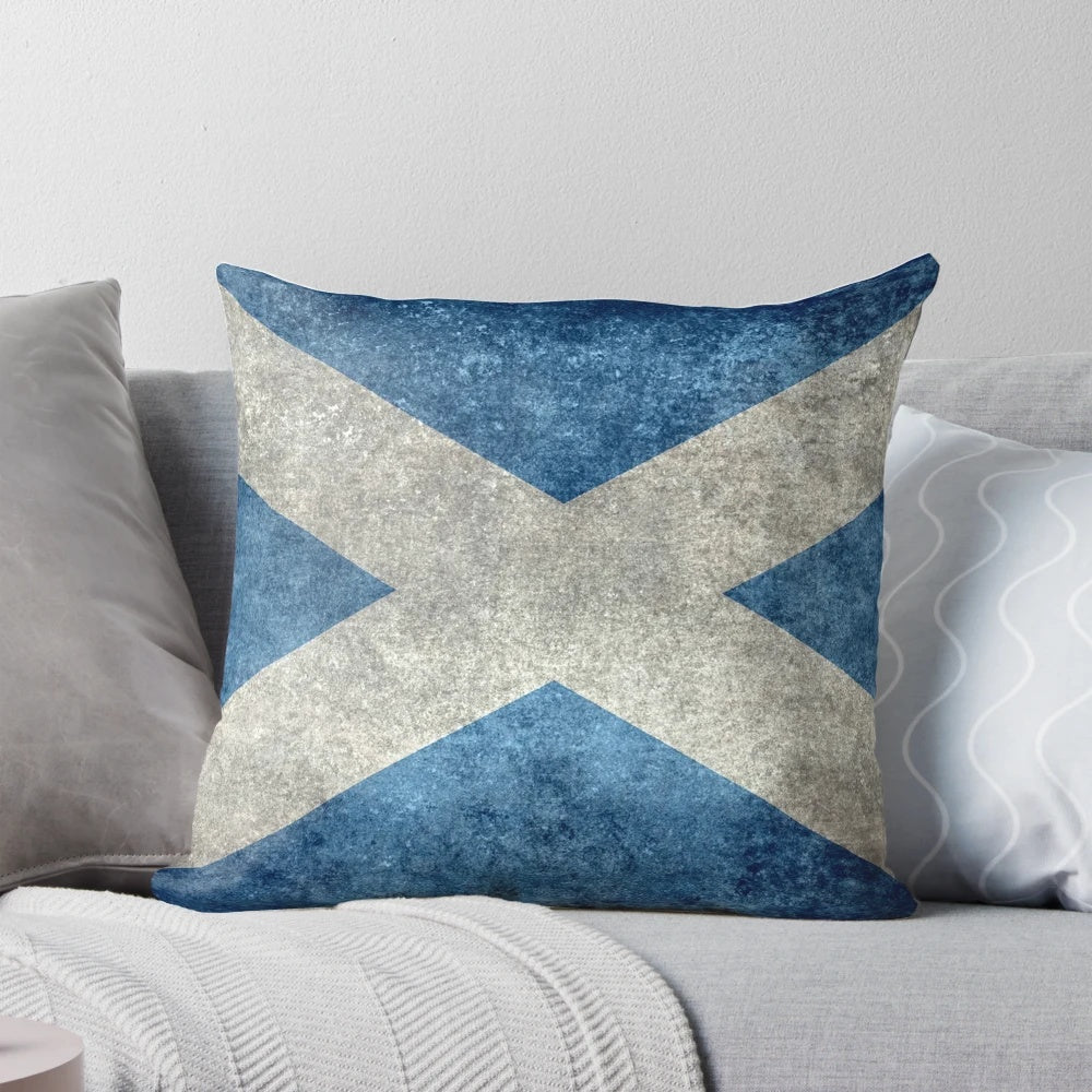 A vintage-style pillow featuring the Scottish flag, with a distressed, textured appearance.