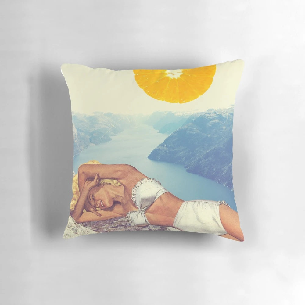A vintage-inspired pillow featuring a colorful collage design with orange, pastels, and nature elements.