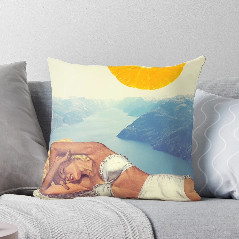A vintage-inspired pillow featuring a colorful collage design with orange, pastels, and nature elements.