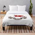 A soft, plush blanket with the iconic White Star Line logo and vintage design.