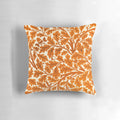 Vintage-inspired throw pillow featuring a William Morris oak leaf textile pattern in rust orange and cream colors.
