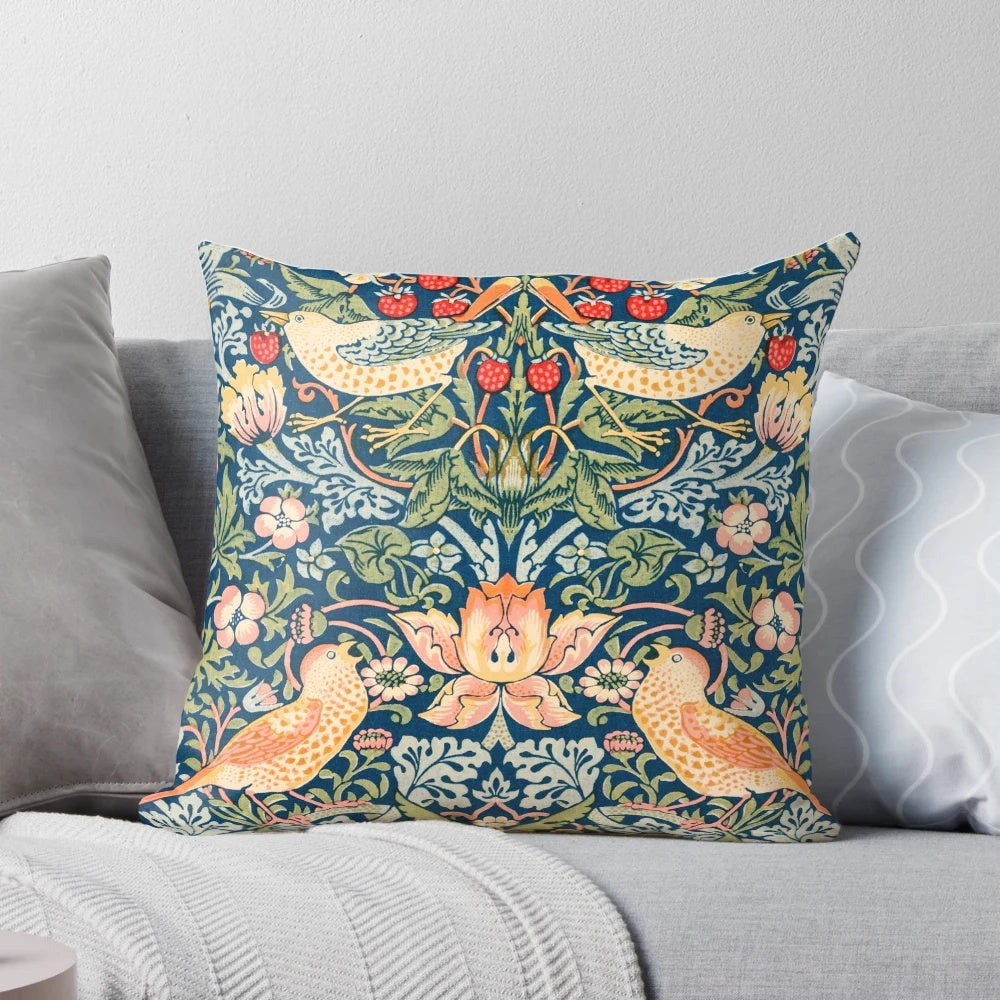 Detailed illustration of the William Morris 'Strawberry Thief' pattern featuring ornate birds and strawberries on a vintage-inspired pillow.