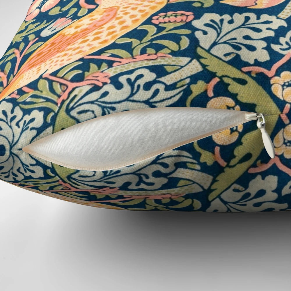 Detailed illustration of the William Morris 'Strawberry Thief' pattern featuring ornate birds and strawberries on a vintage-inspired pillow.