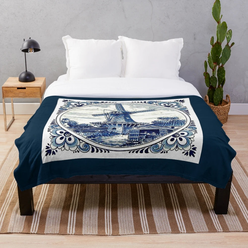 Vintage windmill print plush blanket featuring a whimsical Dutch Blue Delft style design
