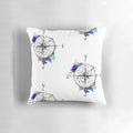 Watercolor compass design on a blue and white pillow, representing the spirit of adventure and exploration.
