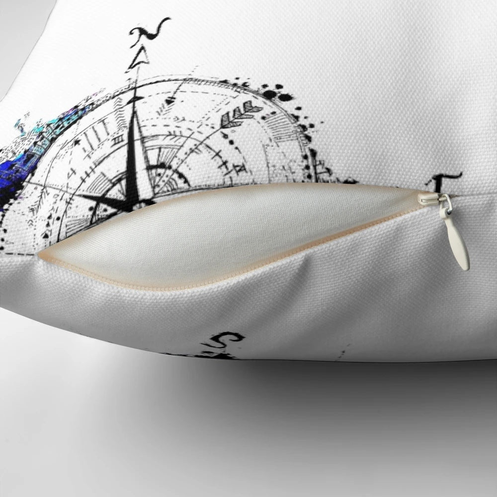 Watercolor compass design on a blue and white pillow, representing the spirit of adventure and exploration.