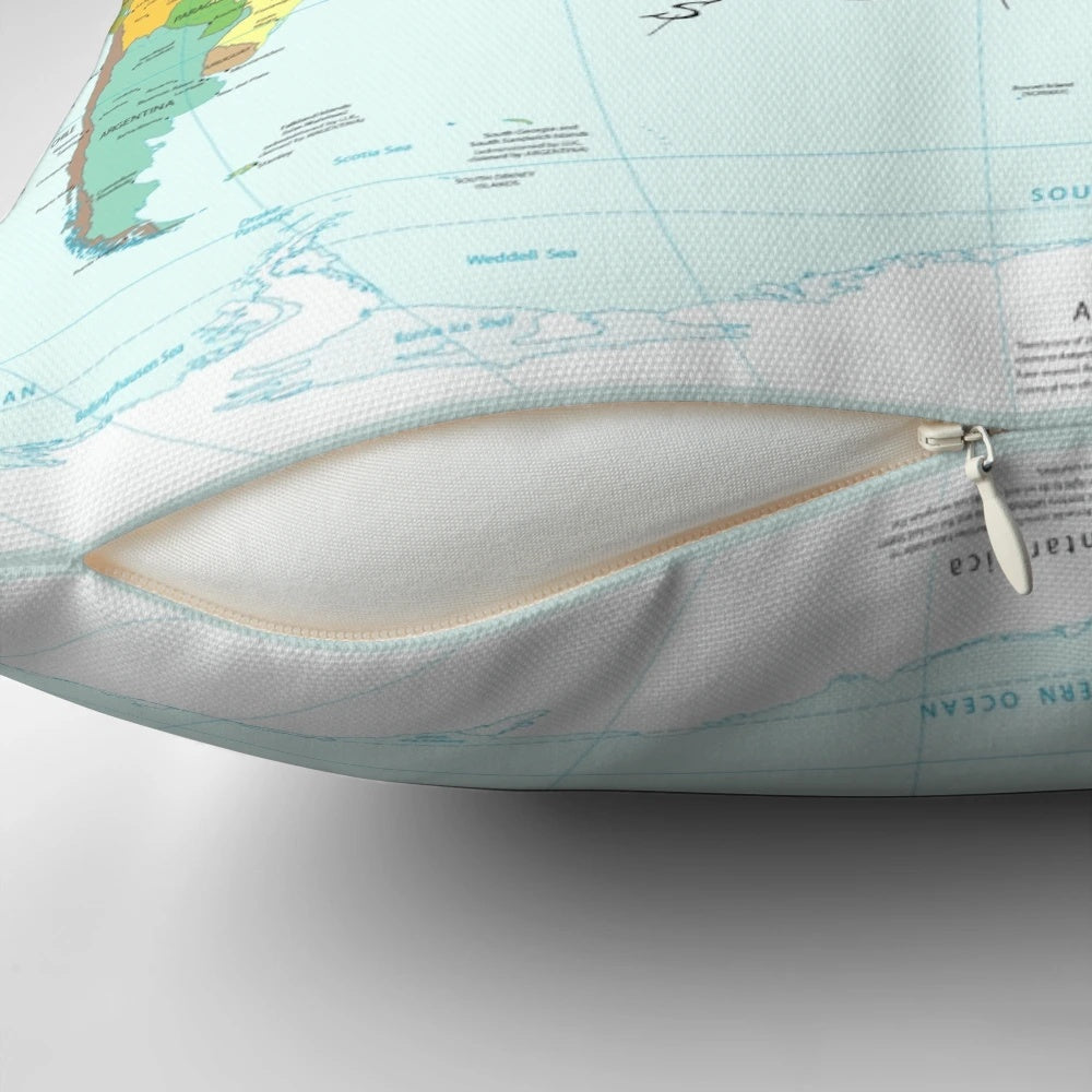 A throw pillow featuring the travel quote "I haven't been everywhere but it's on my list" with a compass rose and world map design.