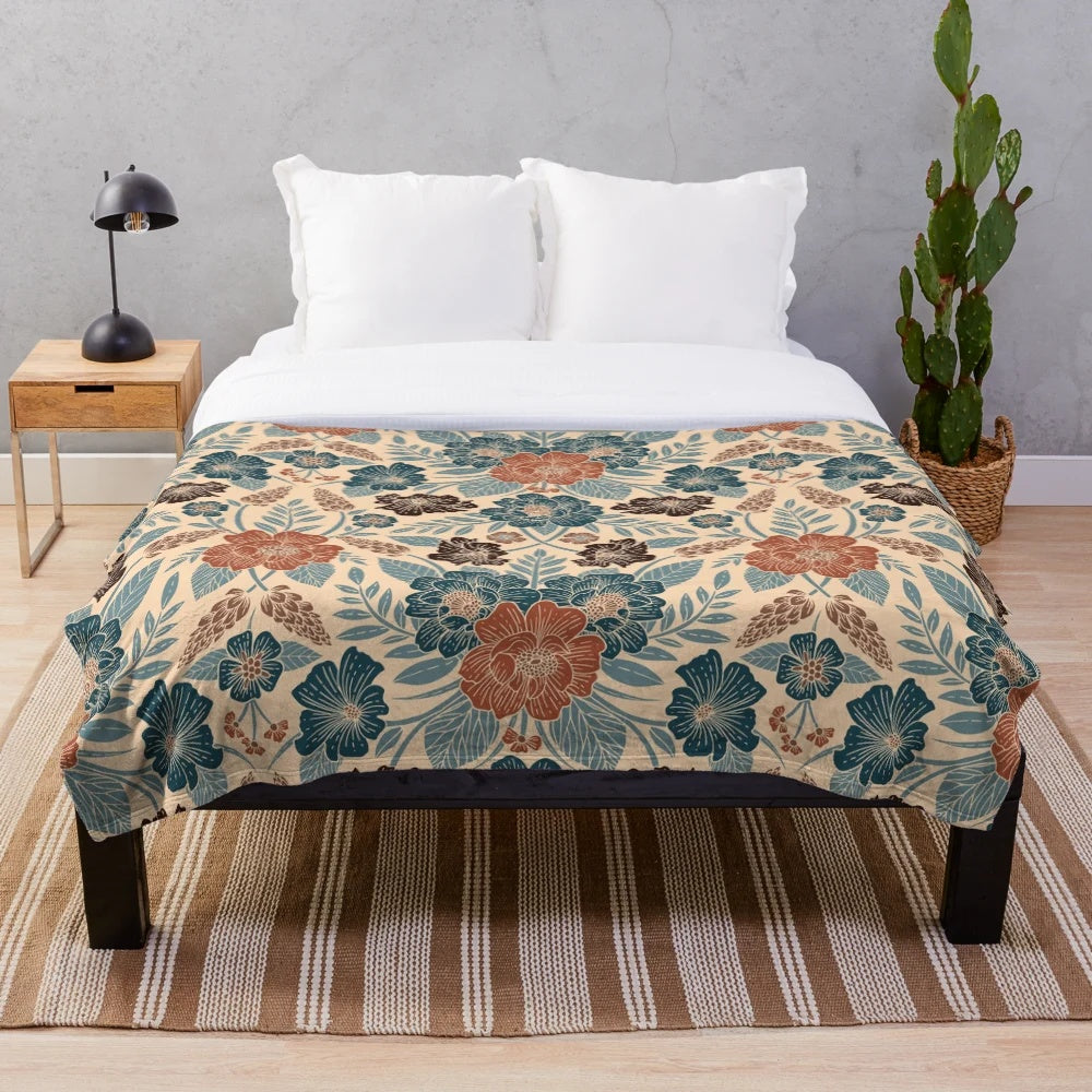 Soft and plush floral patterned blanket in shades of blue, brown, and rust