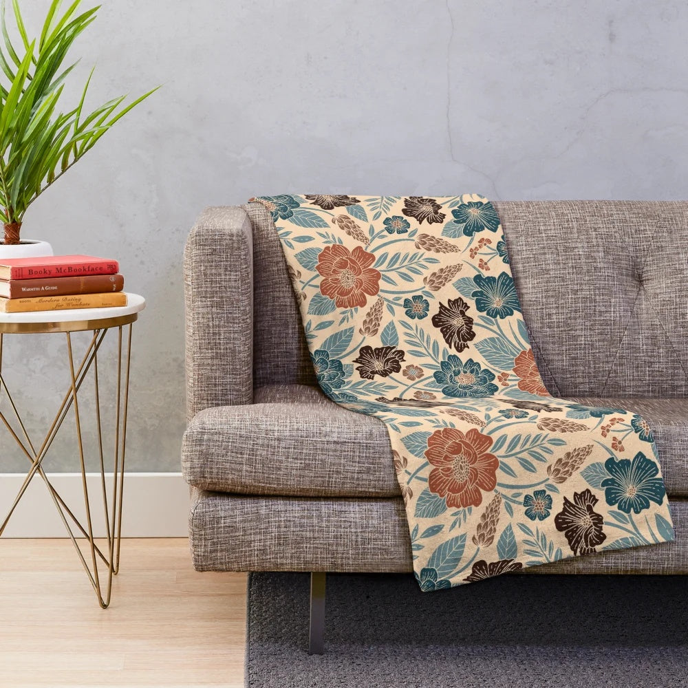 Soft and plush floral patterned blanket in shades of blue, brown, and rust