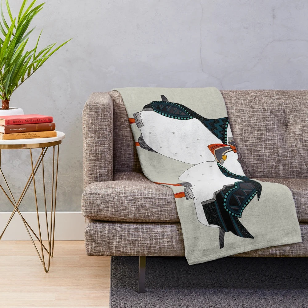 Warm grey plush blanket with a puffin bird design, perfect for nature lovers and cozy home decor.