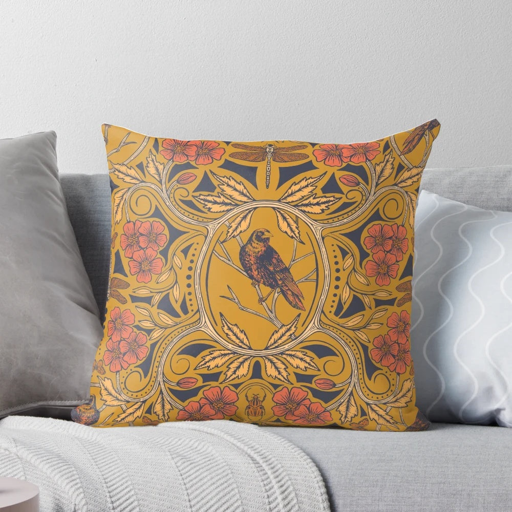 Warm mustard yellow and orange throw pillow with crow and dragonfly floral design in art nouveau botanical boho style