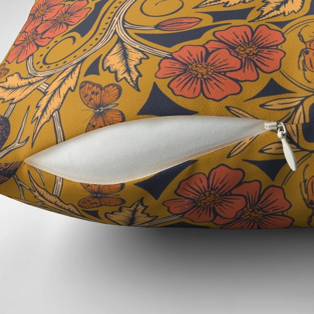 Warm mustard yellow and orange throw pillow with crow and dragonfly floral design in art nouveau botanical boho style
