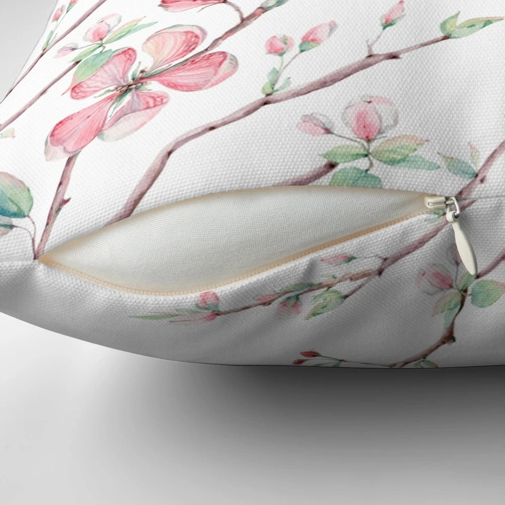 A beautifully detailed watercolor design of delicate apple blossoms in pink, white, and light blue on a decorative pillow.