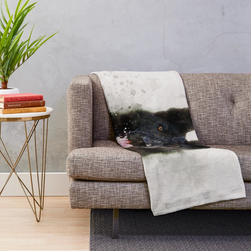 Watercolor painting of a black German shepherd dog on a plush blanket