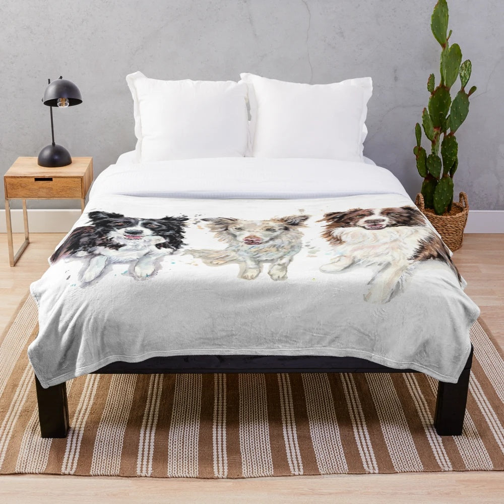 Watercolor painting of border collies on a plush blanket