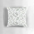 Watercolor painting of green eucalyptus leaves on a decorative pillow cover