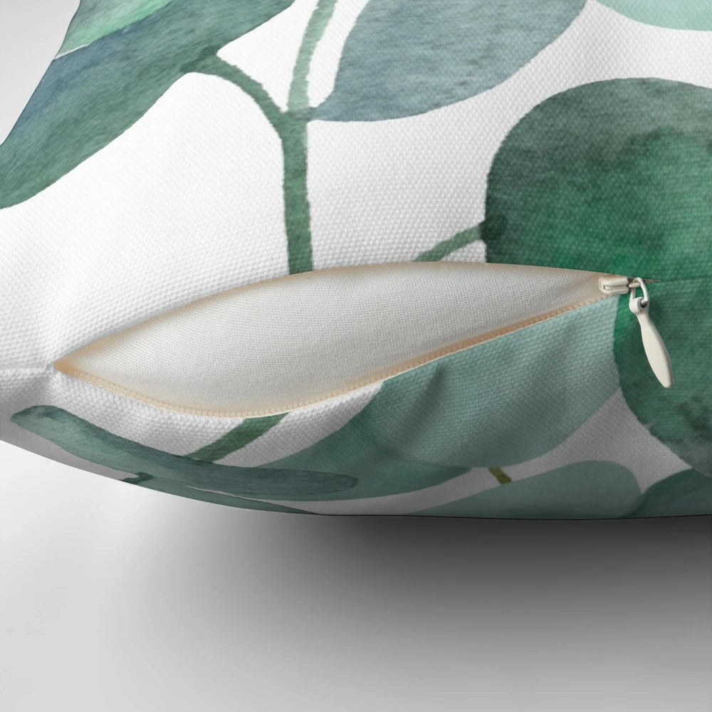 Watercolor painting of green eucalyptus leaves on a decorative cushion for home decor