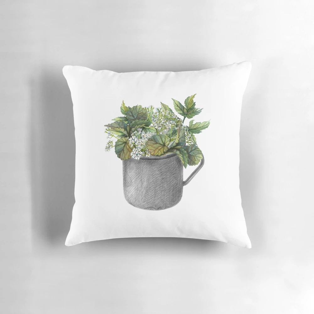 Decorative throw pillow with a watercolor painting of a green forest and wild white flowers