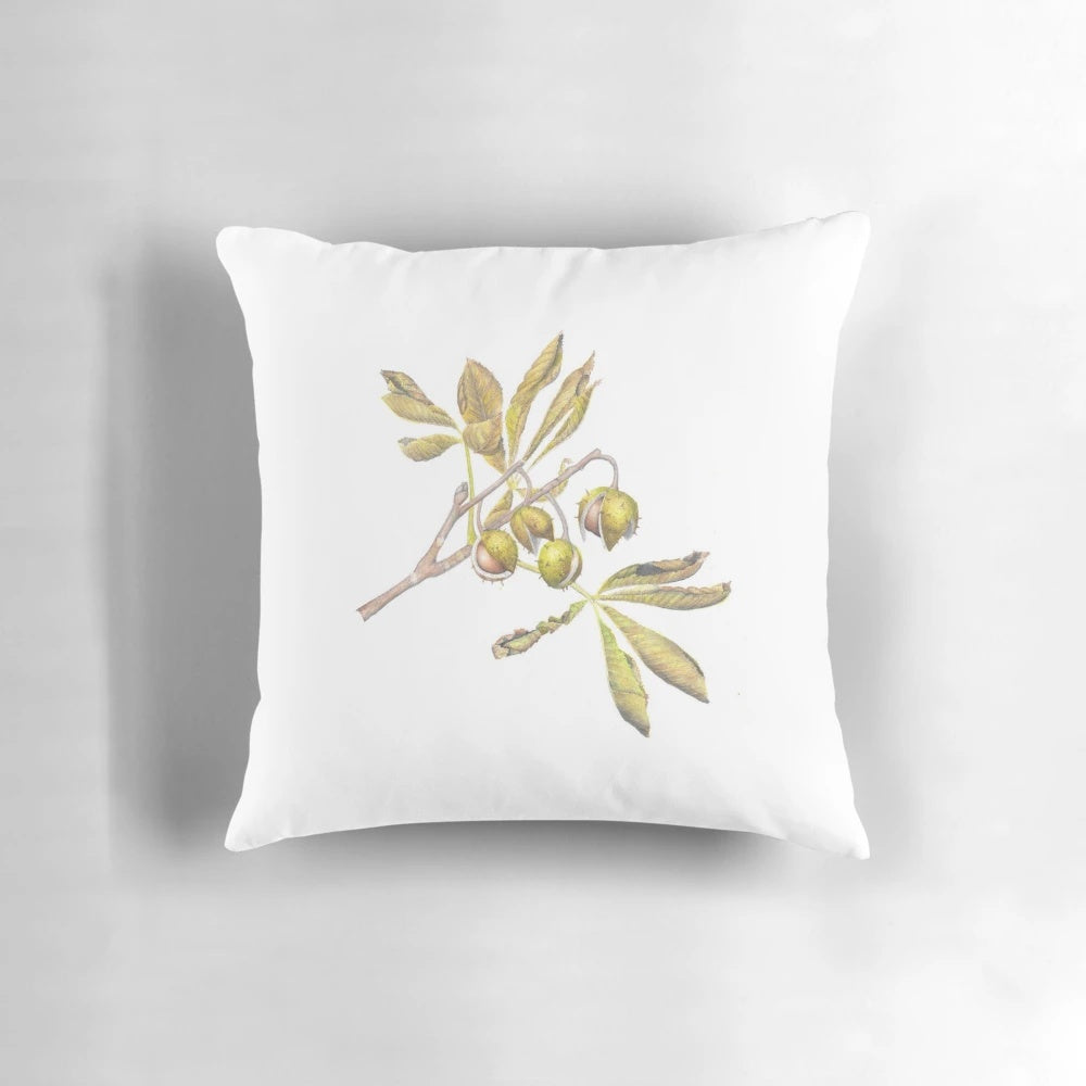 A watercolor illustration of horse chestnut leaves and conkers on a decorative pillow.