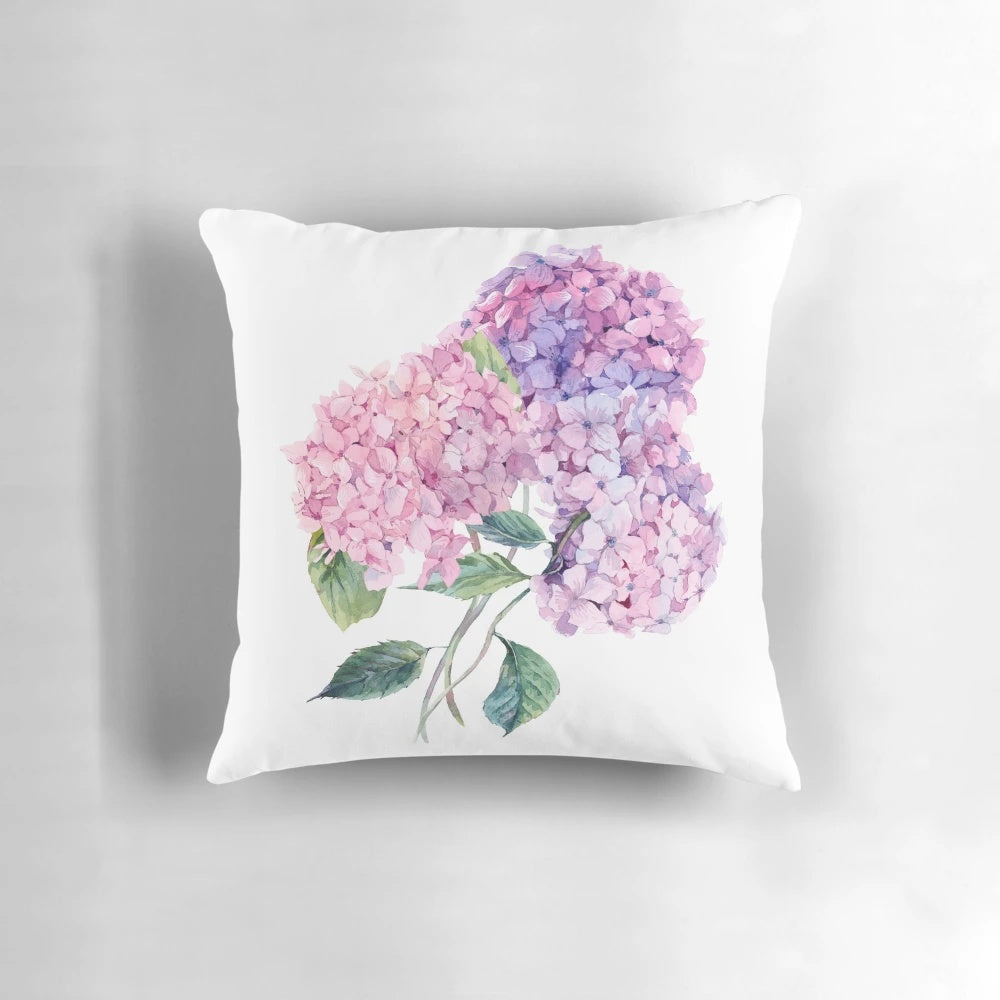 Vibrant watercolor painting of a blooming hydrangea branch on a soft, plush throw pillow.