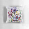 Vibrant watercolor painting of purple iris flowers on a decorative throw pillow.