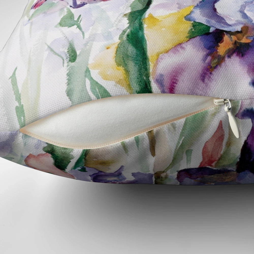 Vibrant watercolor painting of purple iris flowers on a decorative throw pillow.