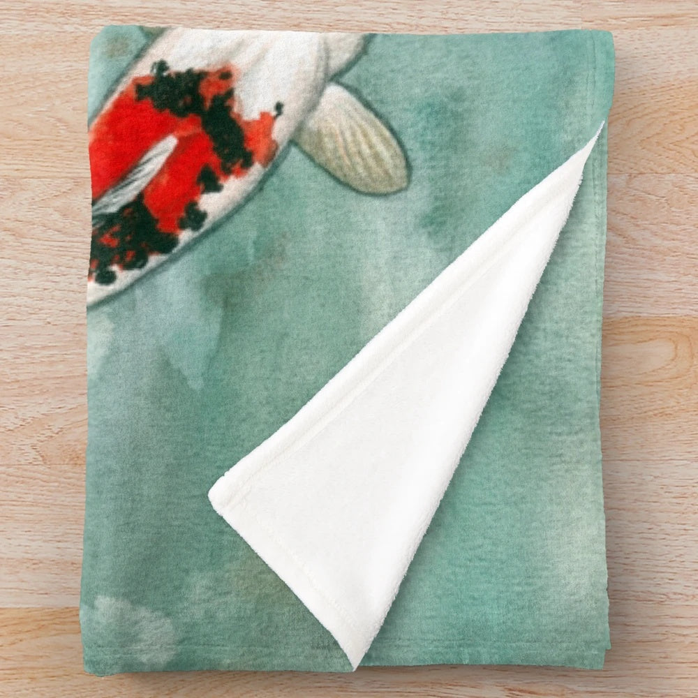 Watercolor koi fish artwork on a plush blanket for cozy aquatic-inspired home decor