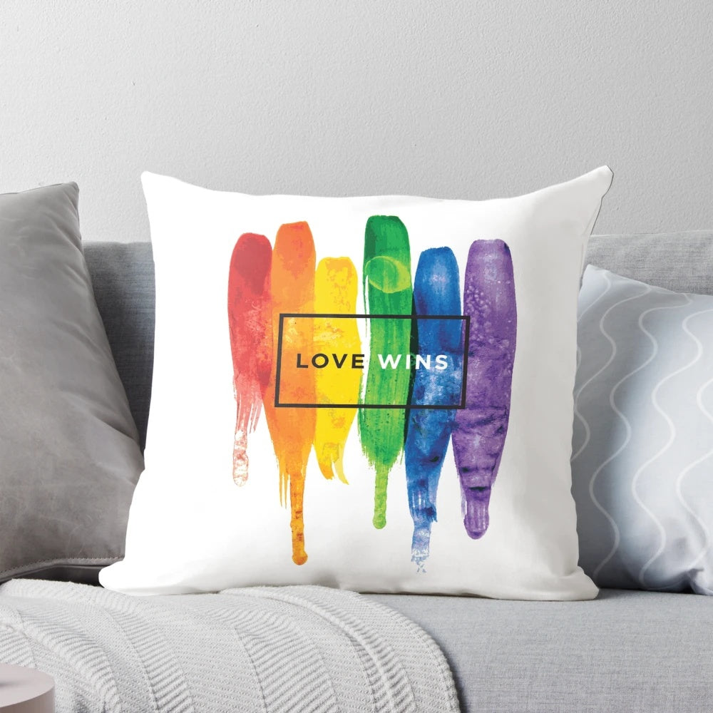 Watercolor LGBTQ love wins rainbow paint typographic design on a soft, plush pillow