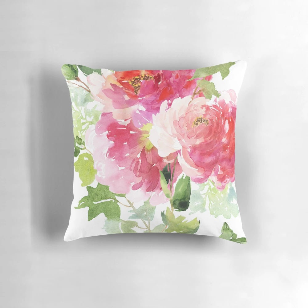 A beautiful watercolor painting of pink peonies on a soft throw pillow for romantic home decor.