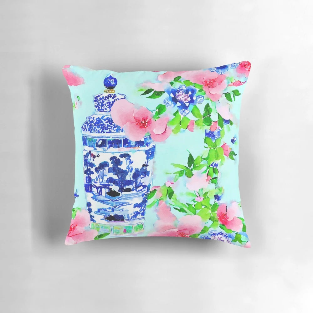 Decorative pillow featuring a watercolor painting of peonies and blue and white chinoiserie ginger jars.