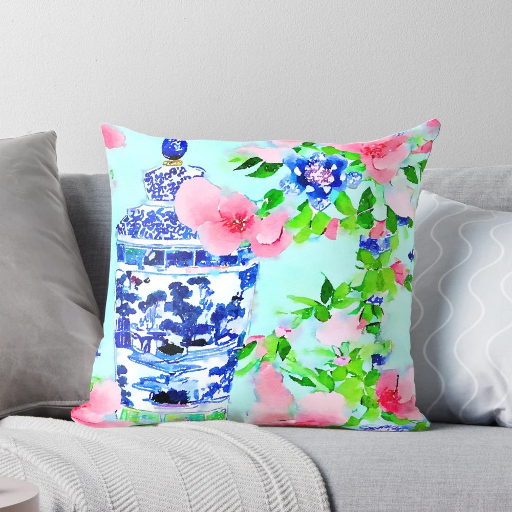 Decorative pillow featuring a watercolor painting of peonies and blue and white chinoiserie ginger jars.