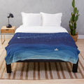 Watercolor-style plush blanket featuring a sailboat on a night sea with shooting stars