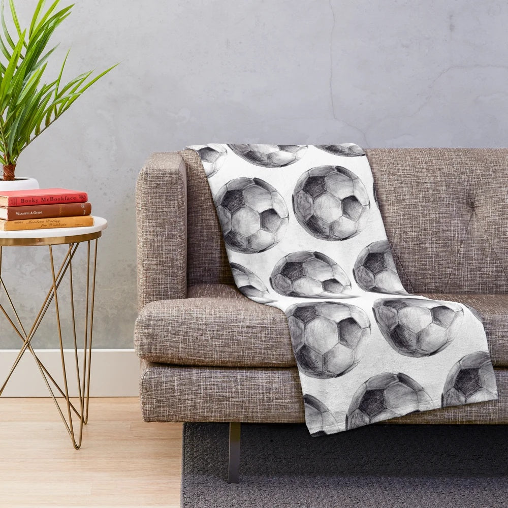 Watercolor plush sports blanket with soccer-themed design