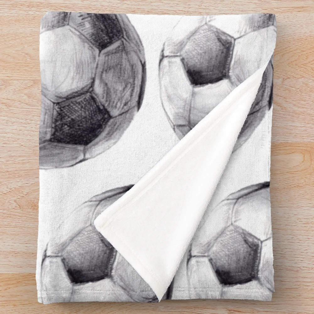 Watercolor plush sports blanket with soccer-themed design