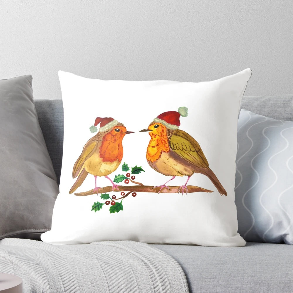 Watercolor painting of a robin bird perched on a branch, printed on a cozy throw pillow for Christmas decor.