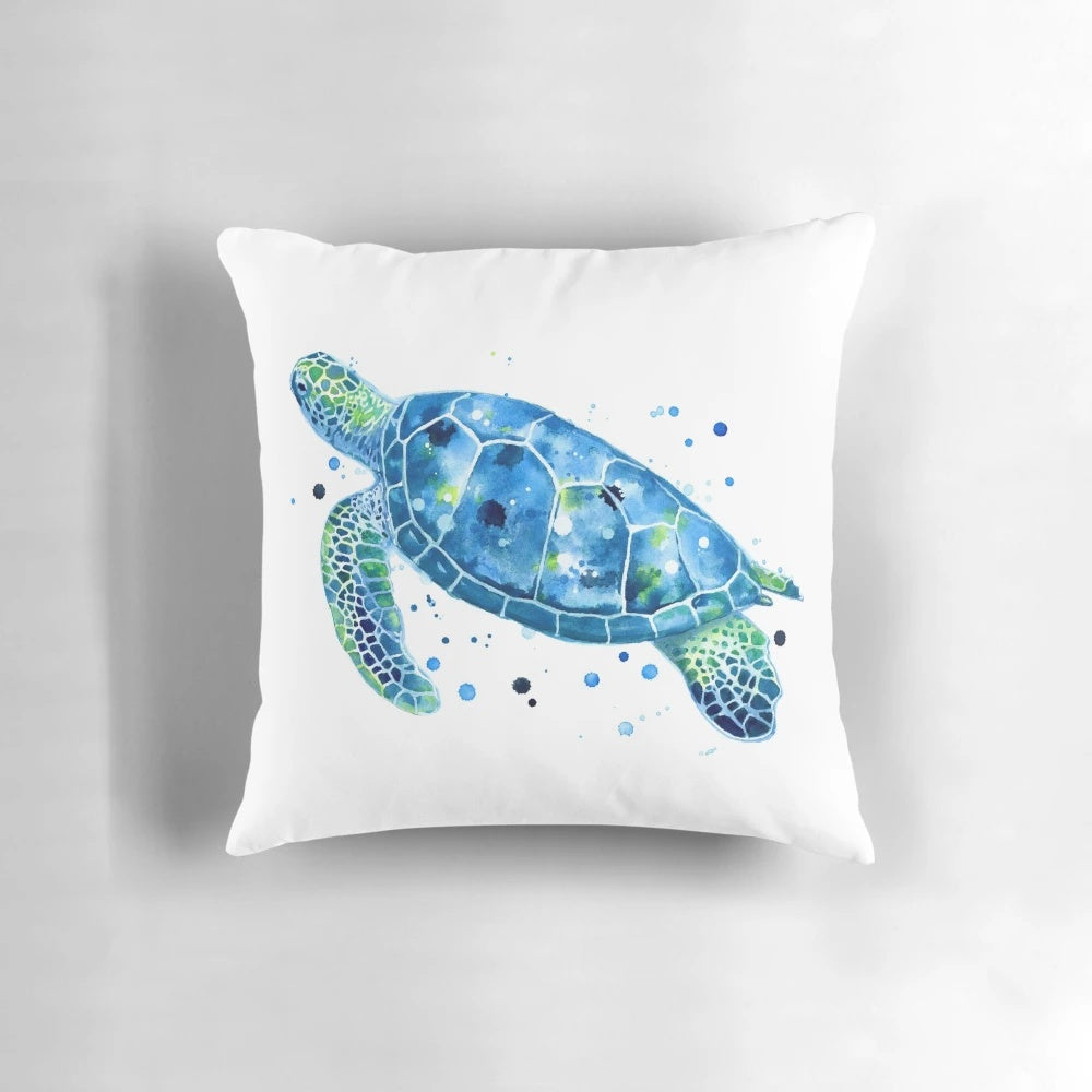 Vibrant watercolor image of a sea turtle on a plush, coastal-inspired pillow.
