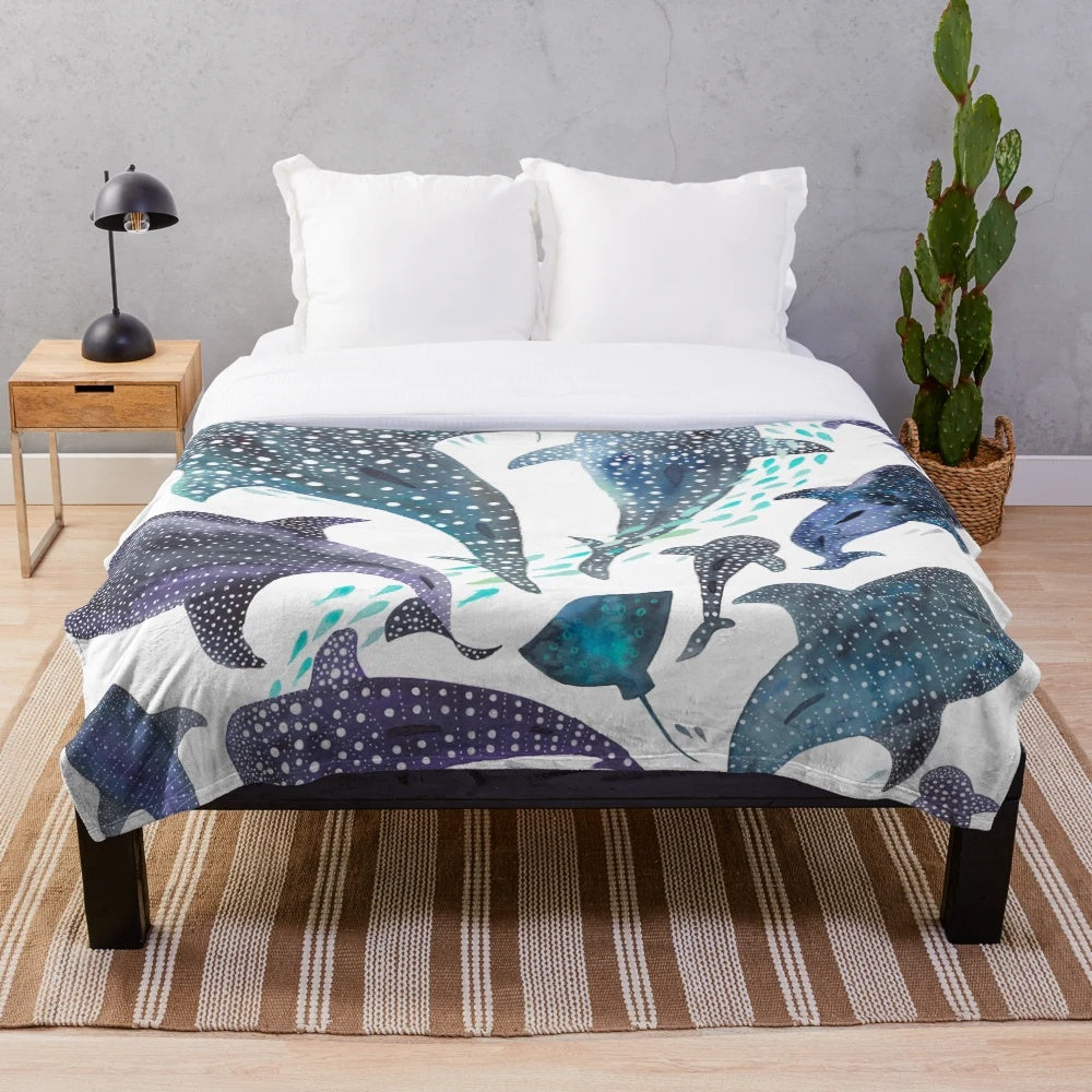 Watercolor print plush blanket featuring whale shark, ray, and other ocean creatures