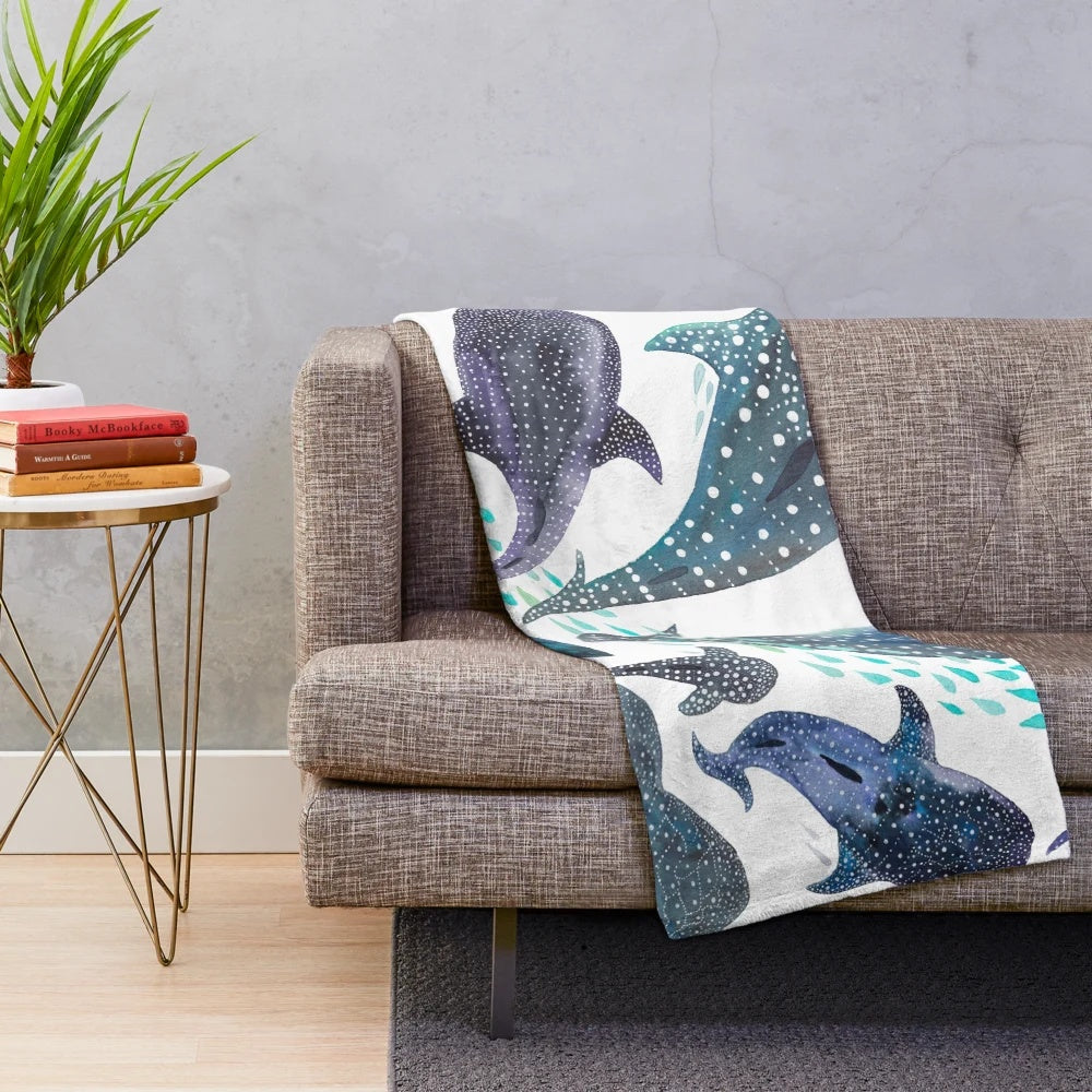 Watercolor print plush blanket featuring whale shark, ray, and other ocean creatures