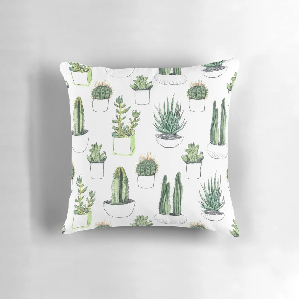Vibrant watercolor illustration of cacti and succulent plants on a soft, plush pillow.