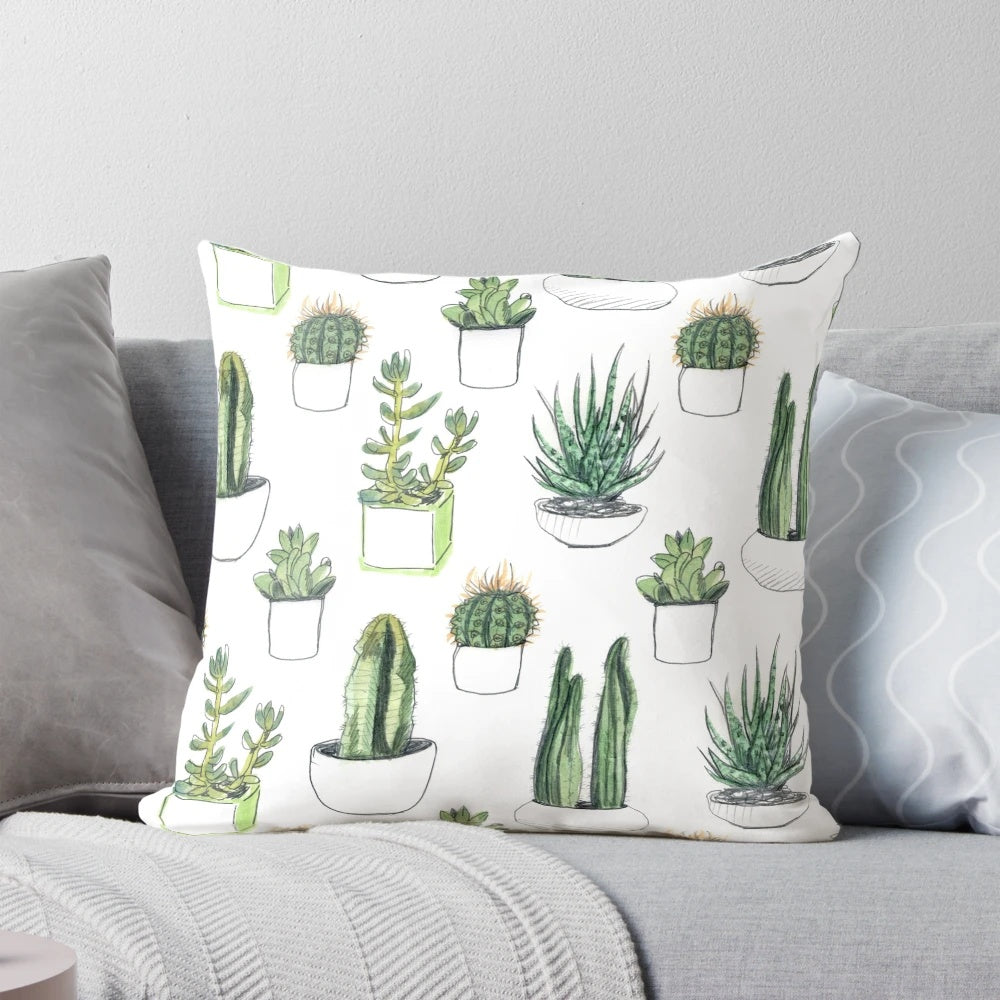 Vibrant watercolor illustration of cacti and succulent plants on a soft, plush pillow.