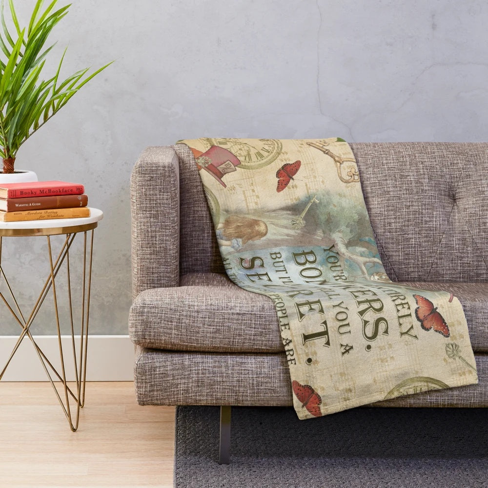 Plush blanket featuring a collage design with Alice, Cheshire Cat, and inspirational quote
