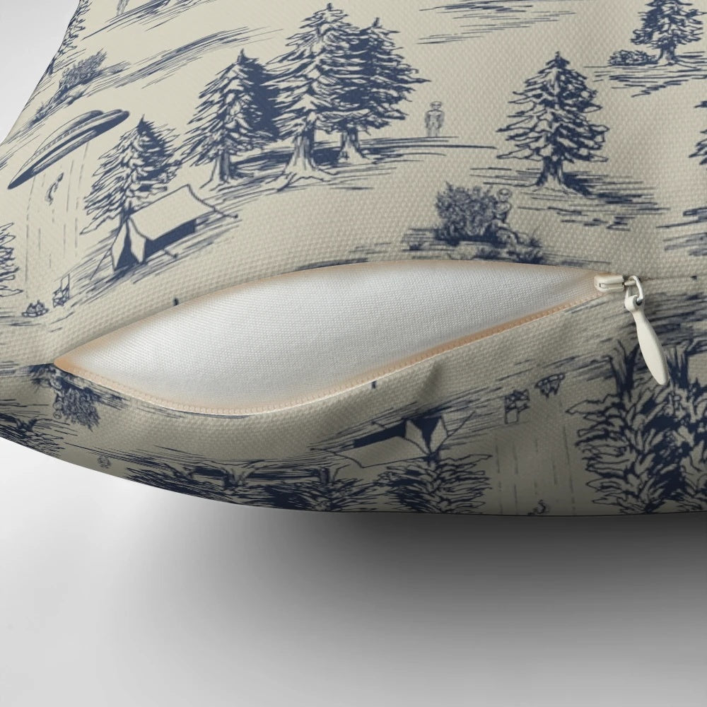 A blue pillow featuring a whimsical alien abduction-themed toile de jouy pattern.