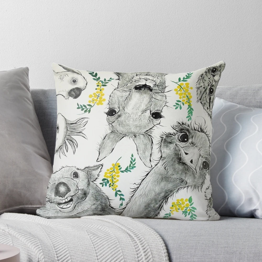 Colorful cartoon illustration of Australian native animals including a wombat, kangaroo, emu, cockatoo, and tawny frogmouth on a decorative pillow.