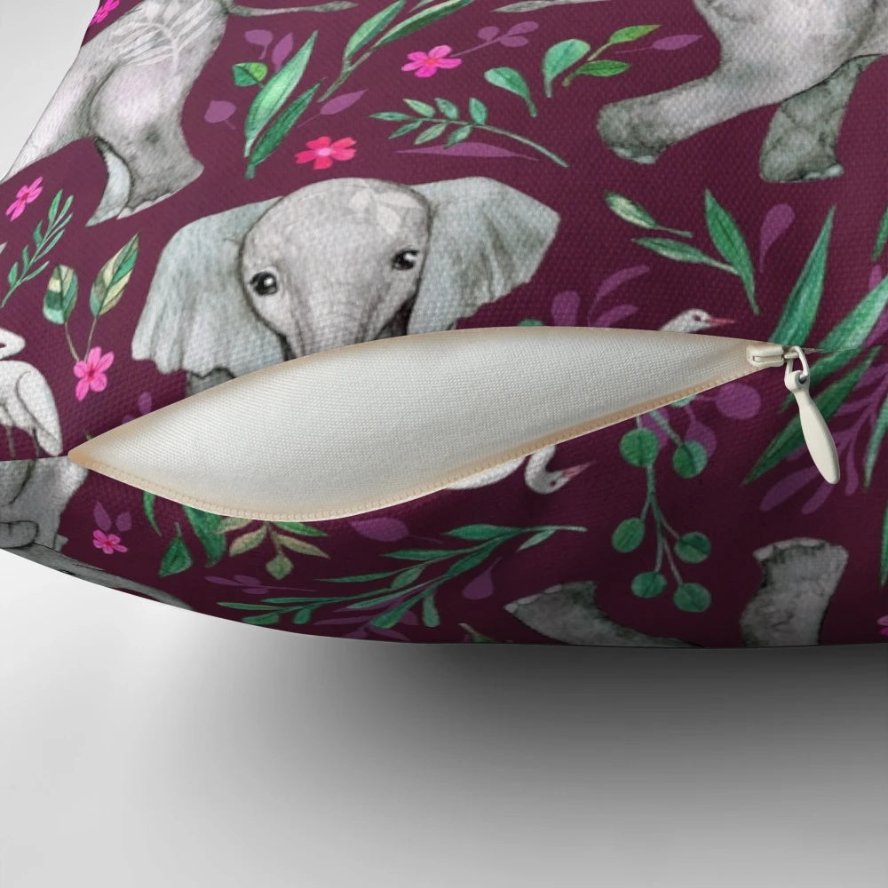 Whimsical watercolor painting of baby elephants and egret birds on a burgundy red throw pillow