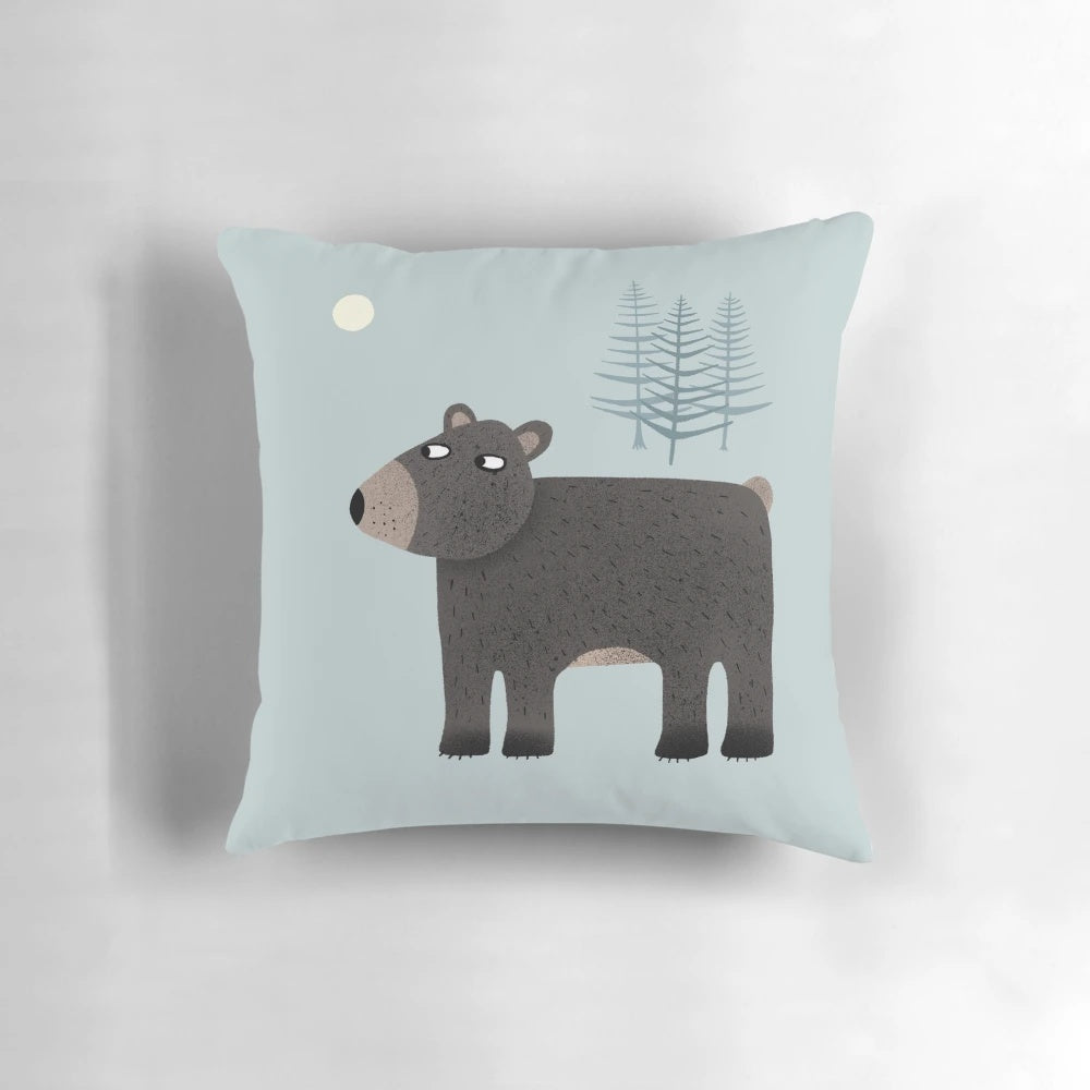 Charming pillow featuring a bear, trees, and a crescent moon in a night sky