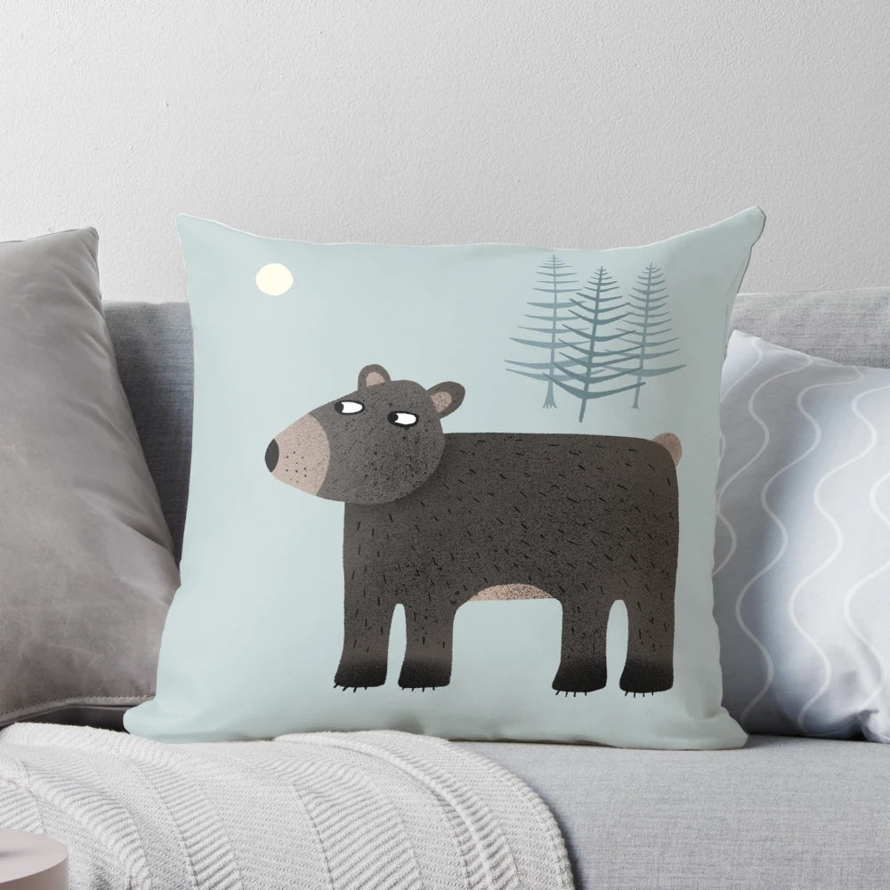Charming pillow featuring a bear, trees, and a crescent moon in a night sky
