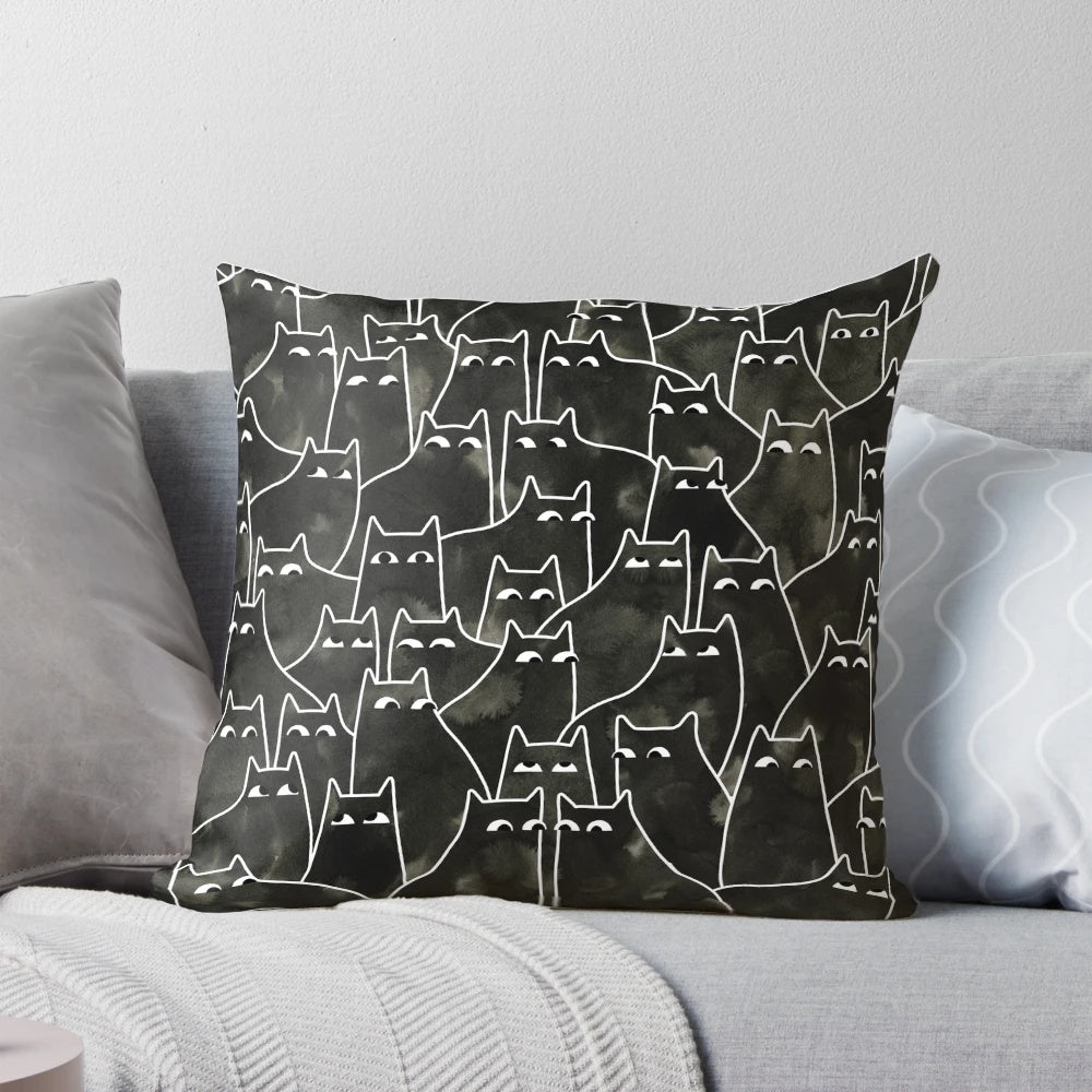Whimsical illustration of a suspicious-looking black cat on a decorative throw pillow