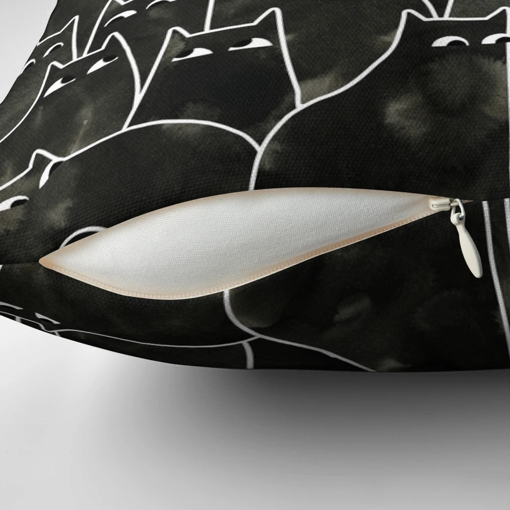 Whimsical illustration of a suspicious-looking black cat on a decorative throw pillow