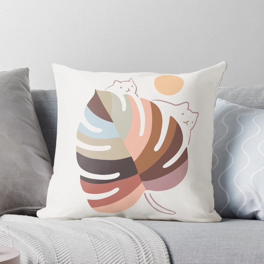 A whimsical pillow featuring a beautiful cat in a lush, plant-filled landscape.